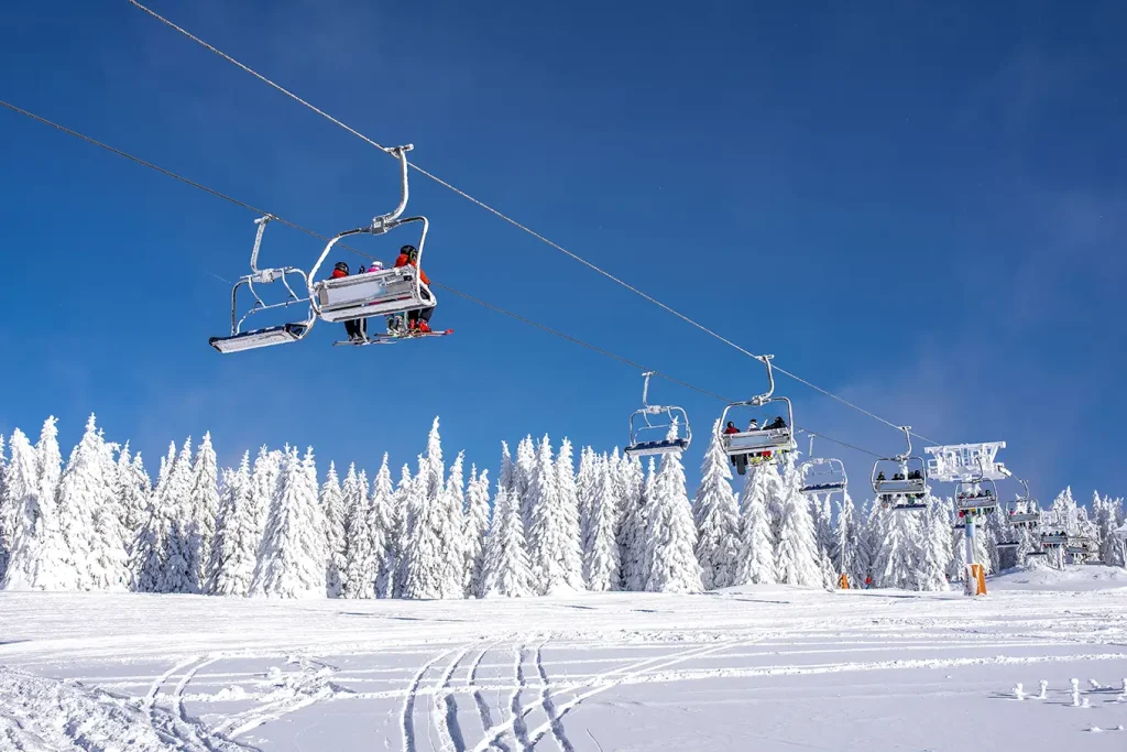 skiers-ski-lift-mountain-resort-with-sky-mountains