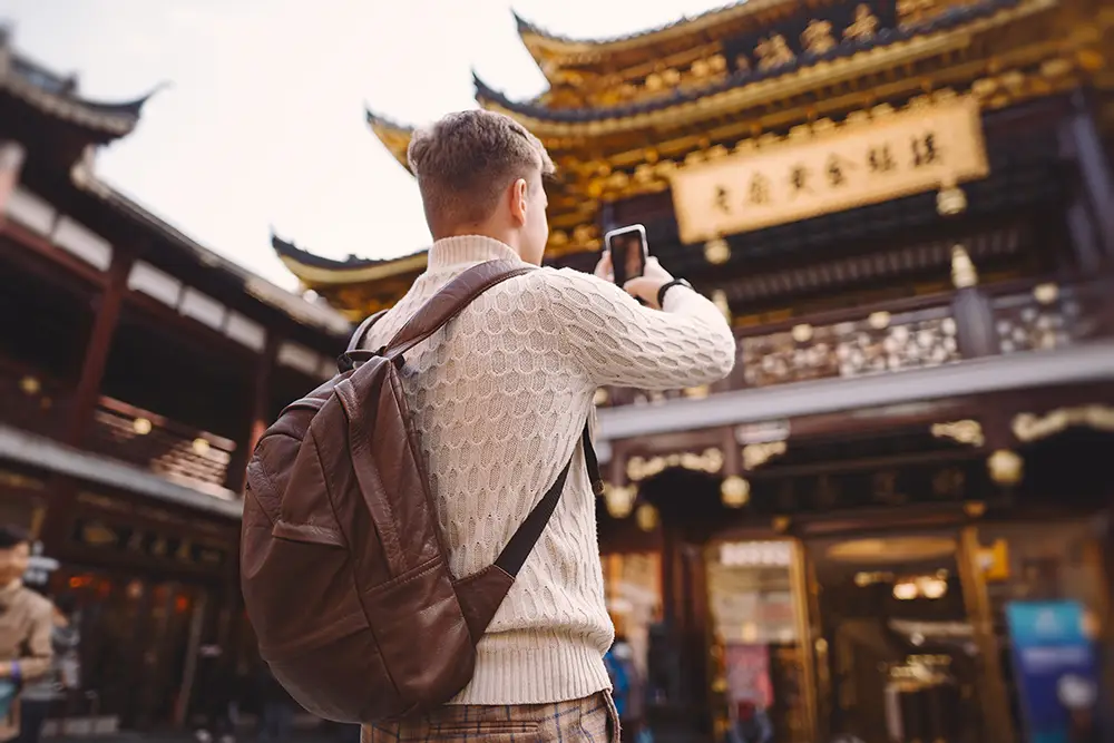 male-tourist-taking-photos-pagoda-yuyuan-market-shanghai